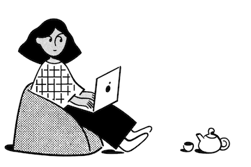 Woman sitting on a beanbag with tea and her laptop.